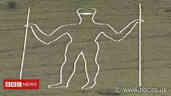 Long Man of Wilmington carving given face mask makeover
