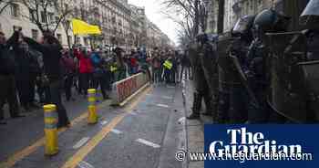 Police and gilets jaunes scuffle during Paris protest over new security bill – video