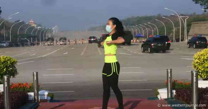 Watch: Oblivious Woman Continues Her Aerobics Workout as Military Coup Unfolds Behind Her