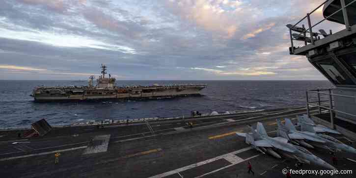 2 US Navy carrier strike groups drill together in the disputed South China Sea, sparking complaints from Beijing