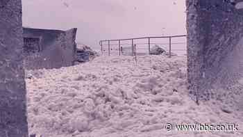 Sea foam showers County Waterford village in Republic of Ireland