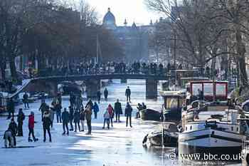 Frozen canals attract ice skaters in the Netherlands