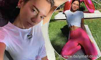 Dua Lipa flaunts her toned physique in workout clothes as she poses in a series of yoga snaps