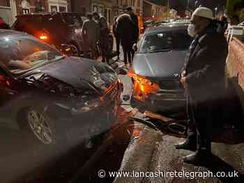 Road closed after vehicle smashes into parked cars