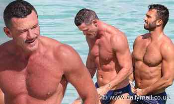 Luke Evans shows off his VERY ripped physique with mystery man in Miami