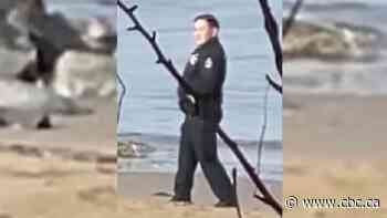 2 police officers caught on video posing with dead man on Vancouver beach