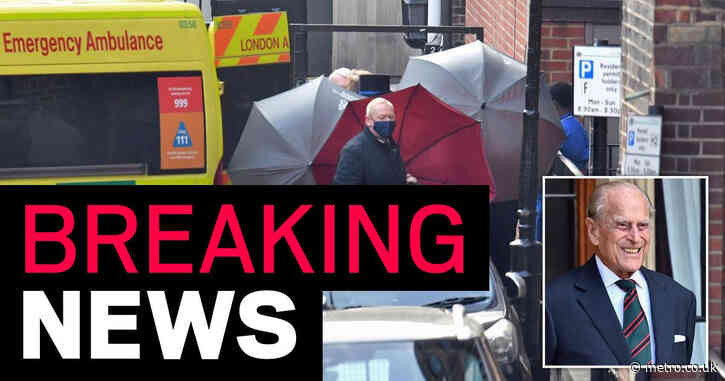 Ambulance leaves Prince Philip’s hospital with patient hidden by umbrellas