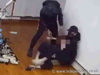 Security camera footage shows woman wrestling with gun-wielding robbers who burst into her home