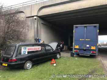 Darwen needs you: confusion as man sets up living space, complete with weights machine and hearse, under M65 bridge