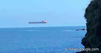 Photos appear to show a giant ship hovering over the water off the English coast - CBS News