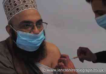 Imam filmed being vaccinated to show it is safe