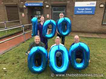 Bolton Town Hall illuminated blue to mark coronavirus vaccination milestone