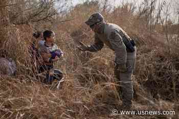 Capturing the Moment a U.S. Border Patrol Agent Reaches Out to a Young Migrant