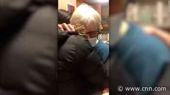 Grandmother breaks down during embrace with granddaughter after a year apart