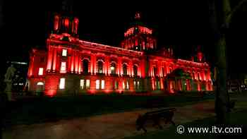 Belfast landmarks lit red to remember victims of terrorism | ITV News - ITV News