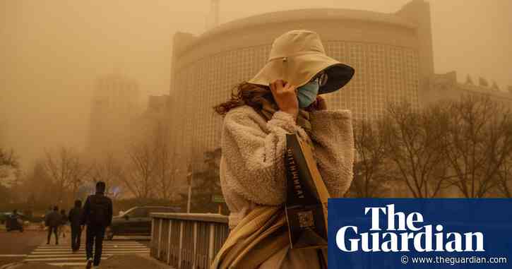 Sandstorm and pollution turn Beijing sky orange – video