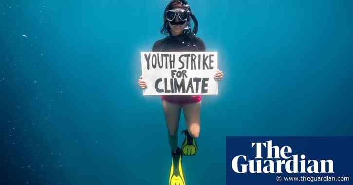 Activist dives for global climate strike in first underwater protest for the planet – video