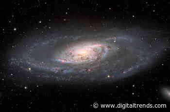 This beautiful galaxy is being warped by its hungry supermassive black hole