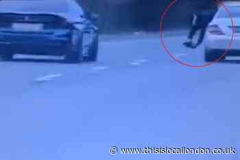 Man caught leaning out of car window while filming in Surrey