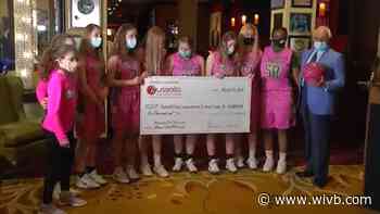 Russell Salvatore helps basketball team reach "Shooting for a Cure" goal with donation