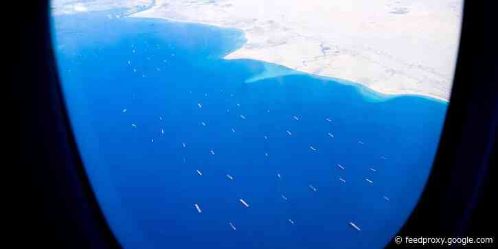 Photos taken from a plane flying over the Suez Canal show epic queue of ships as giant container vessel remains stuck