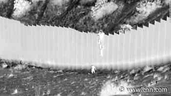 Video shows young children being dropped over 14-foot border fence into the US
