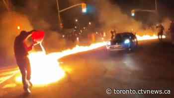 Wild video emerges showing large group set road on fire before stunt driving on Toronto street