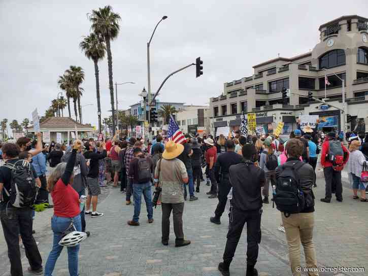 Ahead of ‘white lives’ rally, protests begin at Huntington Beach pier
