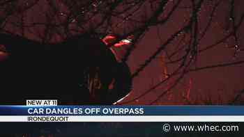 Crash leaves car hanging off overpass