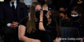 Abigail Evans, 7, wipes away mom's tears during memorial for dad William Evans