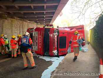 HGV overturns after clipping bridge