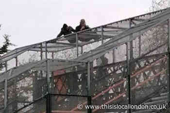 Man atop bridge at Mitcham Eastfields Station helped down