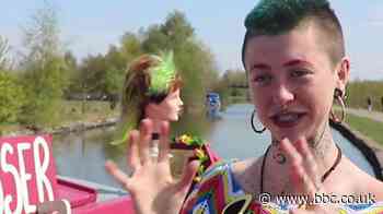 Woman cuts hair on narrowboat along Leeds and Liverpool Canal