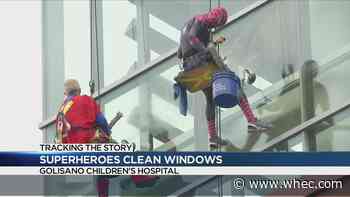 Superheroes wash windows at Golisano Children's Hospital