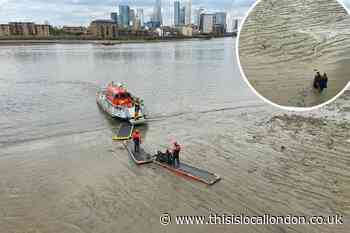 Greenwich: London Fire Brigade rescue women from Thames mud