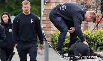 Dan Osborne picks up his security Rottweiler Tyson to protect wife Jacqueline and their family