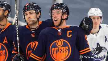 McDavid reaches 100-point milestone in win over Canucks