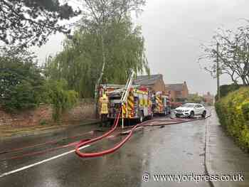 Firefighters tackle house fire in Carlton - road closed