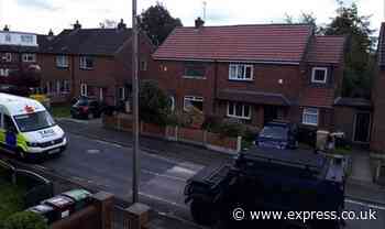 Bolton news: Man wielding axe on roof of house in tense stand-off with armed police - Express