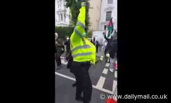 Scotland Yard probes footage of police officer hugging activist and chanting 'free Palestine'