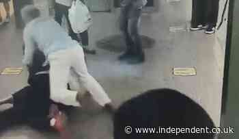 Good Samaritan shown on CCTV jumping on knifeman to stop him stabbing woman on New York subway