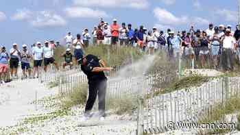 Golfer manages to salvage par after playing shot from the beach