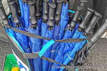 Firm pitches in a buys 30 umbrellas for vaccine bus volunteers