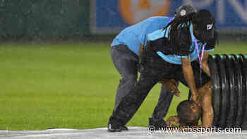 Streaker runs onto field during rain delay at Nationals Park, hides in tarp roller to avoid security