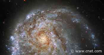 Hubble spots lopsided 'fried egg' galaxy caught in a tug of war     - CNET