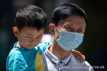 Chinese city locks down neighbourhood amid virus surge - St Helens Star