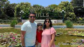 He flew to India to see his parents sick with Covid. Now he's unable to get back to his pregnant wife