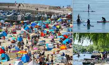 Britons pack beaches and beauty spots as temperatures hit 83F on hottest weekend of the year