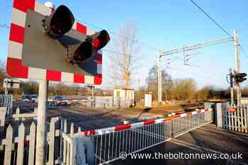 Railway lines blocked after train hits car at level crossing - The Bolton News
