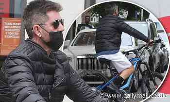Simon Cowell narrowly misses another bike disaster as he cycles wrong direction up one-way street
